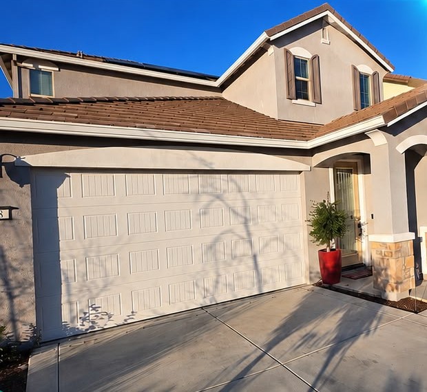 Before: worn white garage door